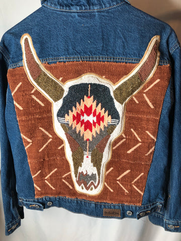 Denim jacket with added hand beaded cow skull on African Mud cloth